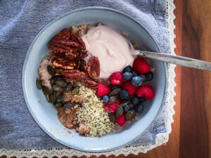 A bowl filled with fruits, yoghurt and kasha