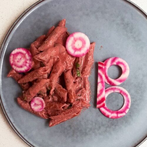 pink pasta with a beet cut into a B shape